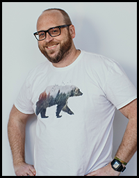 Moose posing for headshot in his white bear shirt